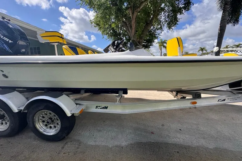 Slide: The Image of 2005 Storm Boats Storm-High Performance on trailer, yellow seats, under blue sky. - 14