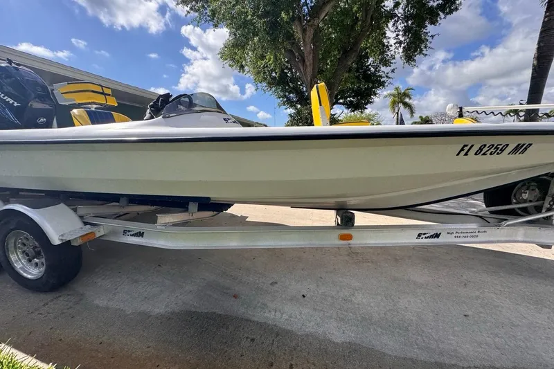 Slide: The Image of 2005 Storm Boats Storm-High Performance on trailer, sunny day, palm trees in background. - 15