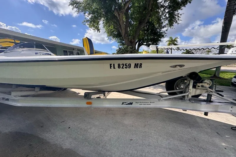 Slide: The Image of 2005 Storm Boats Storm-High Performance on trailer, parked outdoors under blue sky. - 16
