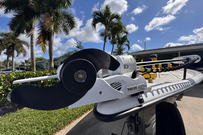 Slide: The Image of 2005 Storm Boats Storm-High Performance with Minn Kota motor, parked outdoors under palm trees. - 20