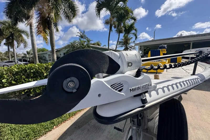 Slide: The Image of 2005 Storm Boats Storm-High Performance with Minn Kota motor, parked under palm trees. - 21