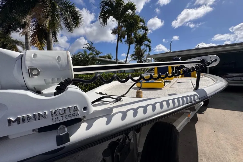 Slide: The Image of 2005 Storm Boats Storm-High Performance with Minn Kota Ulterra motor, parked under palm trees. - 22