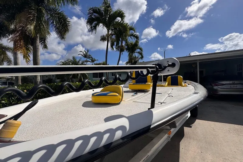 Slide: The Image of 2005 Storm Boats Storm-High Performance boat with yellow seats, parked under palm trees. - 23