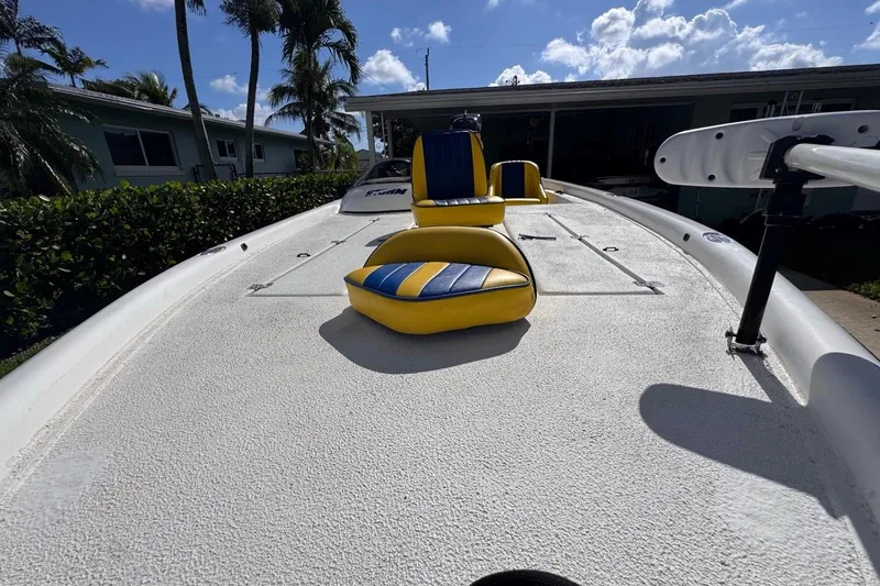 Slide: The Image of 2005 Storm Boats Storm-High Performance with yellow and blue seating, docked under a sunny sky. - 27