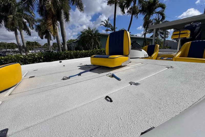 Slide: The Image of 2005 Storm Boats Storm-High Performance with yellow and blue seats, surrounded by palm trees. - 29