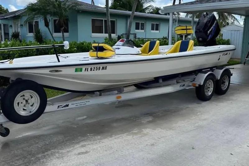 Slide: The Image of 2005 Storm Boats Storm-High Performance on trailer, parked outdoors with palm trees in background. - 3