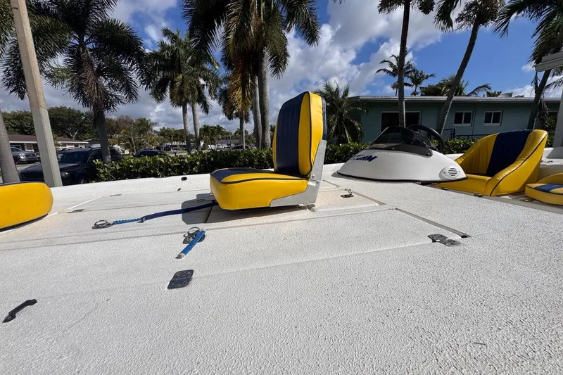 Slide: The Image of 2005 Storm Boats Storm-High Performance with yellow seats, parked under palm trees. - 30
