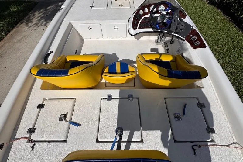 Slide: The Image of 2005 Storm Boats Storm-High Performance interior with yellow seats and steering console. - 39