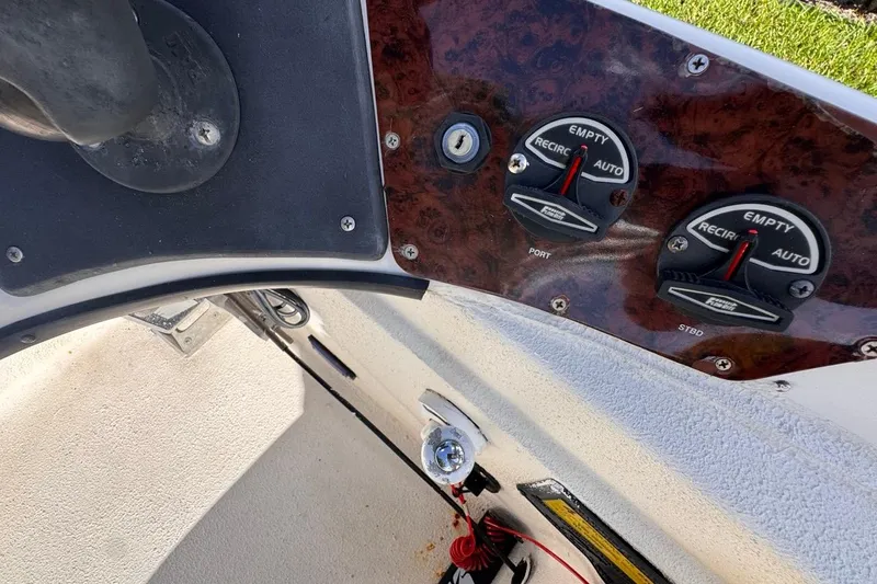 Slide: The Image of Control panel of a 2005 Storm Boats Storm-High Performance vessel, featuring gauges and switches. - 43