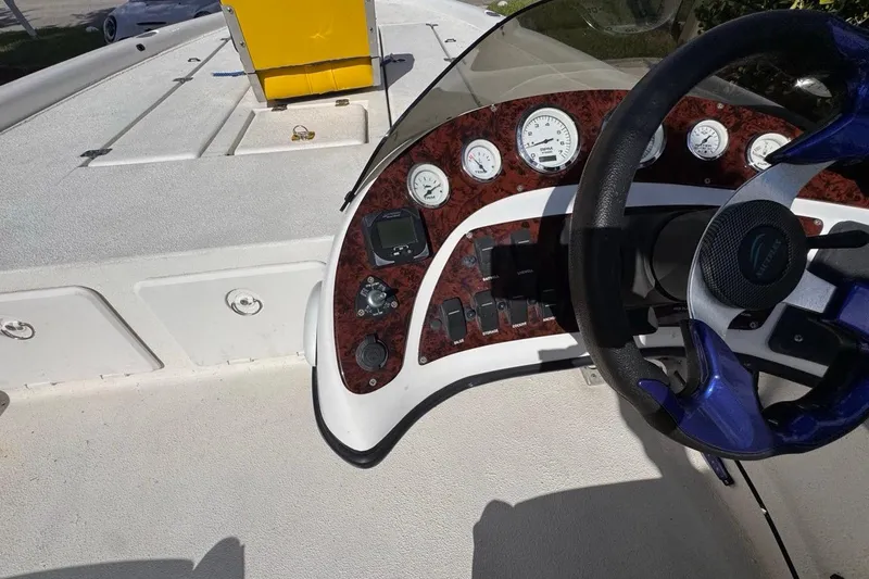 Slide: The Image of Dashboard of a 2005 Storm Boats Storm-High Performance vessel with steering wheel and gauges. - 44