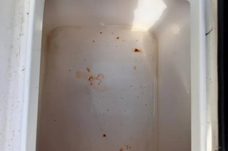 Slide: The Image of Interior of a 2005 Storm Boats Storm-High Performance compartment with rust stains. - 49