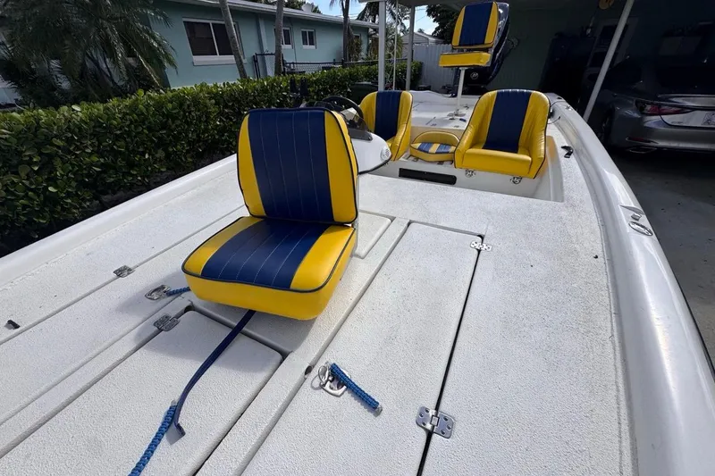 Slide: The Image of 2005 Storm Boats Storm-High Performance with blue and yellow seating, parked outdoors. - 57