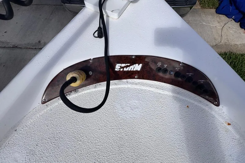 Slide: The Image of Control panel of a 2005 Storm Boats Storm-High Performance vessel, featuring various switches. - 58