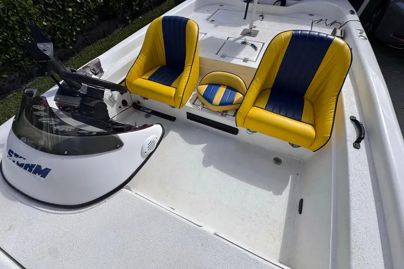 Slide: The Image of 2005 Storm Boats Storm-High Performance interior with yellow and blue seats, steering console. - 64