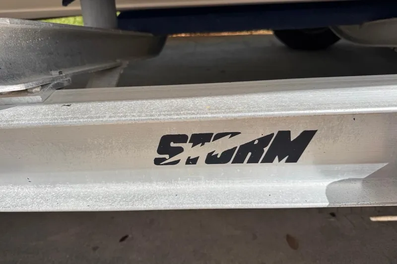 Slide: The Image of 2005 Storm Boats Storm-High Performance trailer with bold logo on metal frame. - 68