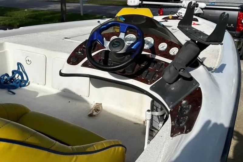 Slide: The Image of 2005 Storm Boats Storm-High Performance with powerful outboard motor, yellow seating, and palm trees in background. - 7