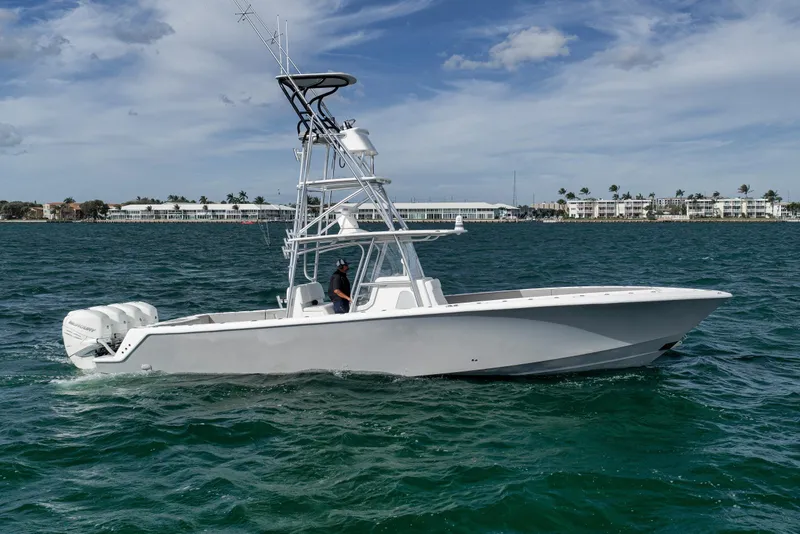 The Image of 2021 SeaVee 390Z boat on open water, featuring a sleek design and multiple outboard engines. - 0