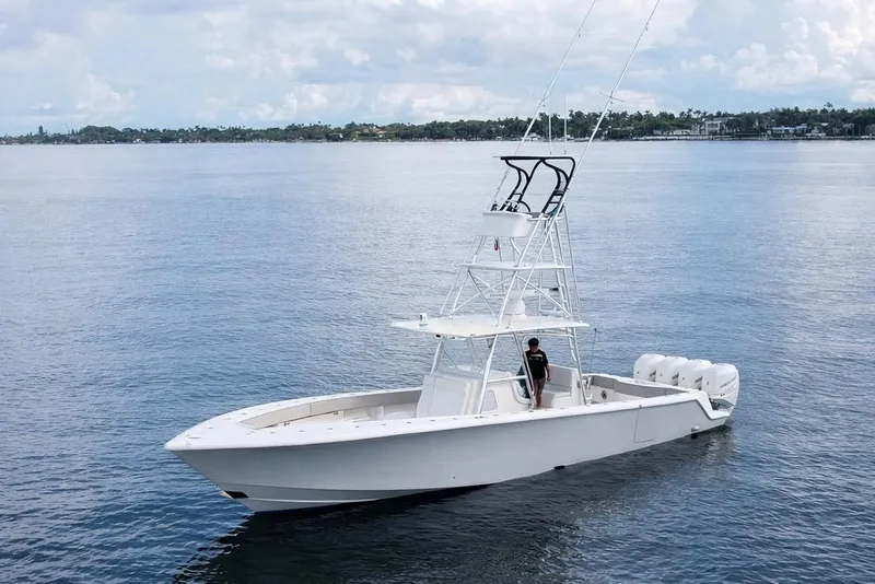 The Image of 2021 SeaVee 390Z boat on calm water with a person onboard. - 1