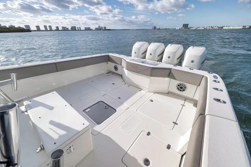 Slide: The Image of 2021 SeaVee 390Z boat with quad engines on open water, city skyline in background. - 10