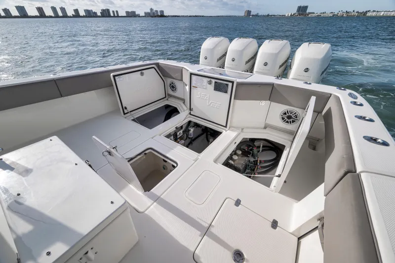 Slide: The Image of 2021 SeaVee 390Z boat with open hatches, quad engines, and ocean backdrop. - 11