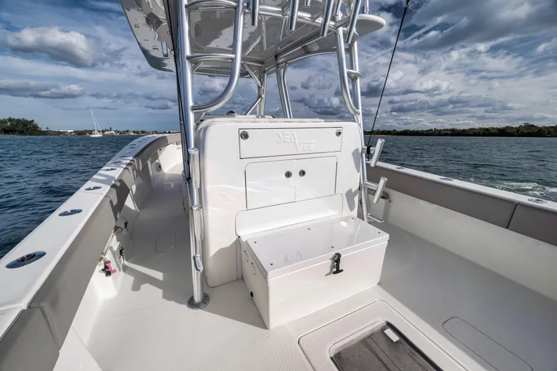Slide: The Image of 2021 SeaVee 390Z boat on water, showcasing deck and seating area under cloudy sky. - 13