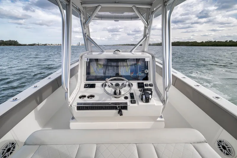 Slide: The Image of 2021 SeaVee 390Z boat helm with steering wheel and navigation system on open water. - 16