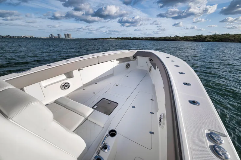 Slide: The Image of 2021 SeaVee 390Z boat on calm water, showcasing spacious deck and seating. - 18