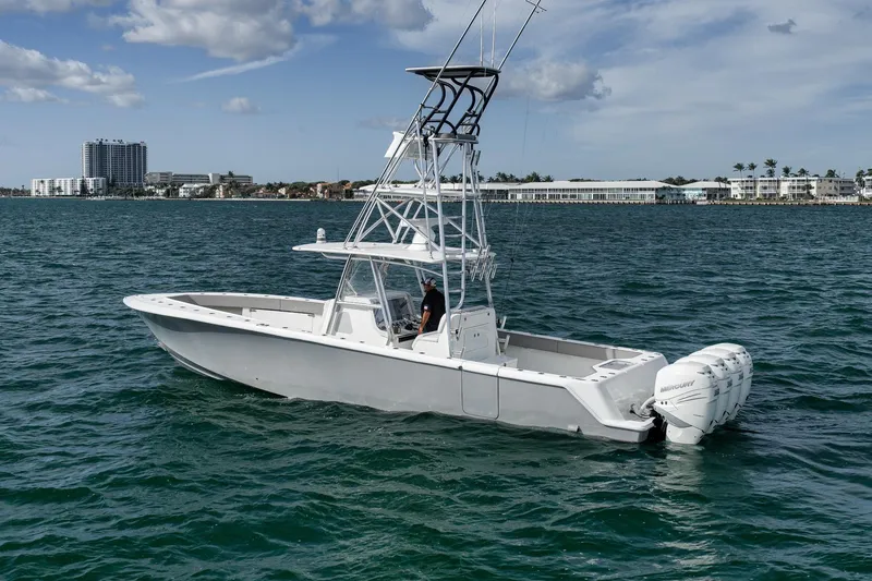Slide: The Image of 2021 SeaVee 390Z boat on water with triple Mercury outboards. - 3