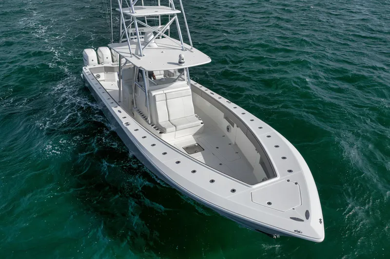 Slide: The Image of 2021 SeaVee 390Z boat cruising on open water, showcasing sleek design and powerful engines. - 5