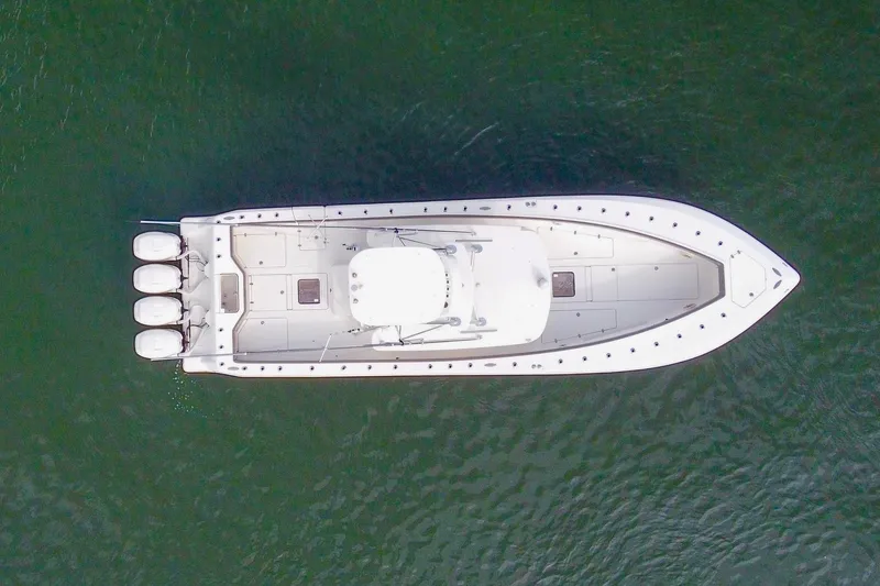 Slide: The Image of Aerial view of 2021 SeaVee 390Z boat with four engines on calm water. - 7