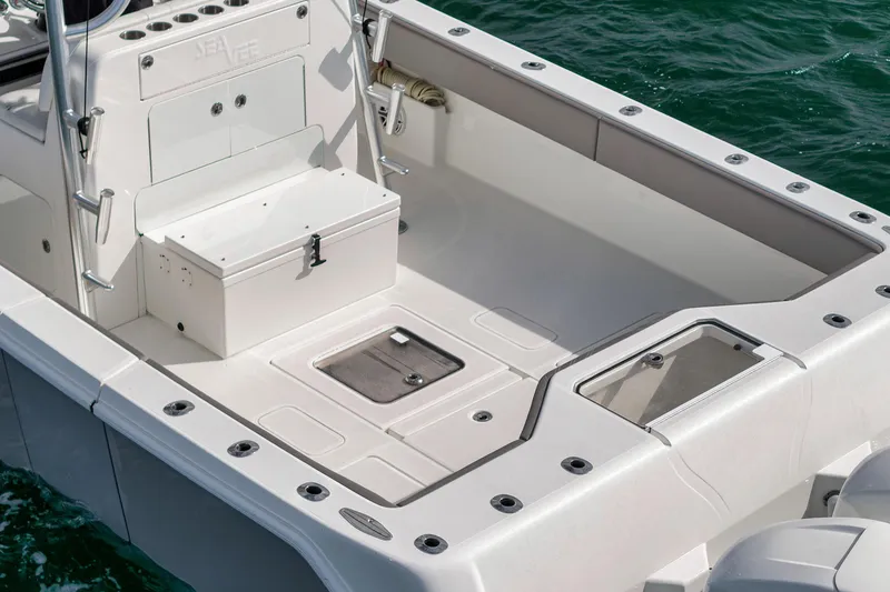 Slide: The Image of 2021 SeaVee 390Z boat deck with storage compartments and rod holders. - 8