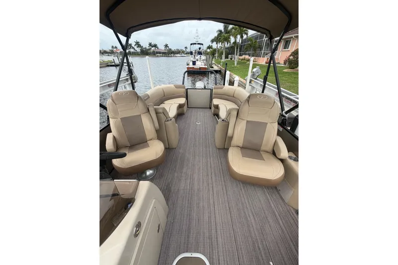 Slide: The Image of 2020 Veranda Relax VR 22 RC pontoon boat interior with beige seating and canopy. - 11