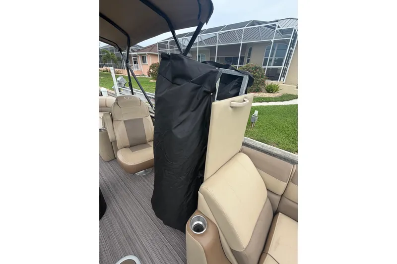 Slide: The Image of 2020 Veranda Relax VR 22 RC boat interior with beige seating and black cover. - 17