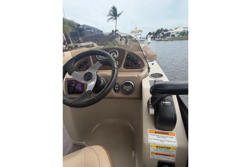 Slide: The Image of Cockpit view of 2020 Veranda Relax VR 22 RC pontoon boat on a calm waterway. - 9