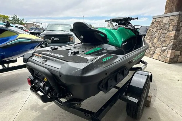 Slide: The Image of 2026 Sea-Doo PWC GTR 230 on trailer, green-black, parked outdoors. - 22