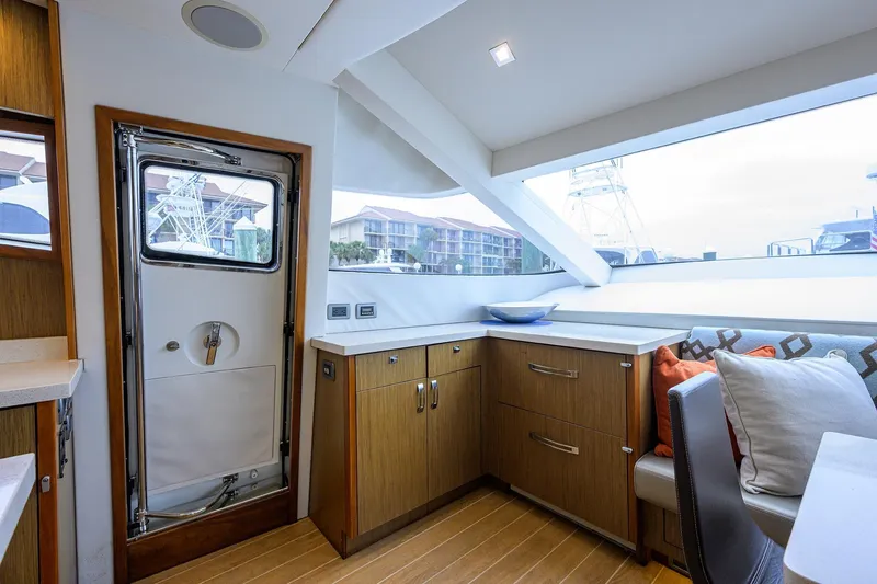 Slide: The Image of Interior of 2013 Hatteras 80 Motor Yacht with modern cabinetry and seating. - 14