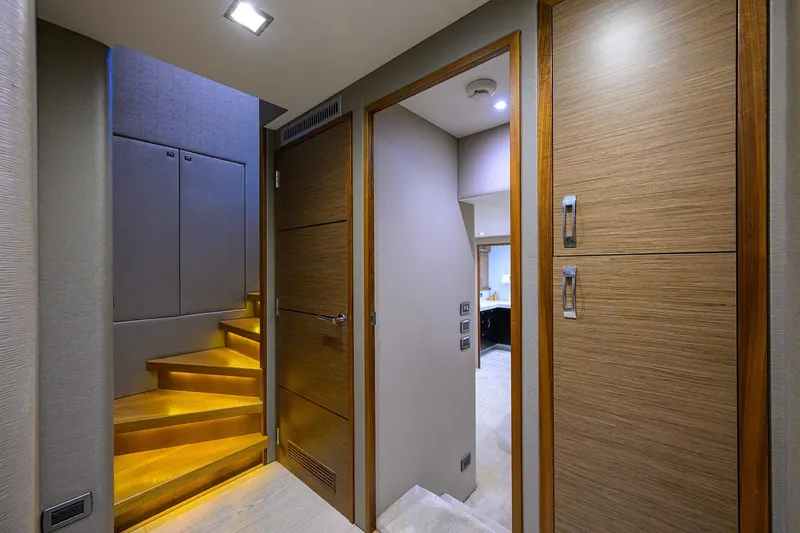 Slide: The Image of Interior of 2013 Hatteras 80 Motor Yacht with illuminated wooden stairs and modern design. - 15