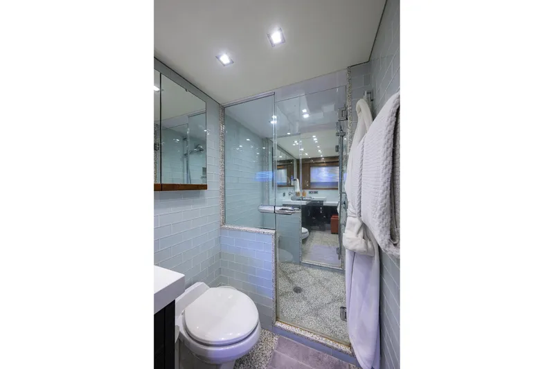 Slide: The Image of Luxurious bathroom in 2013 Hatteras 80 Motor Yacht with modern fixtures and elegant design. - 25