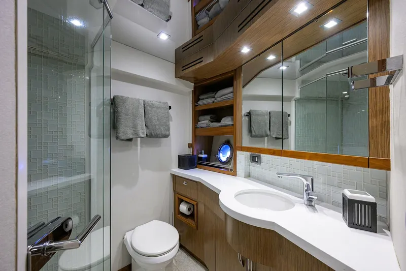 Slide: The Image of Luxurious bathroom in 2013 Hatteras 80 Motor Yacht with modern fixtures and elegant design. - 28