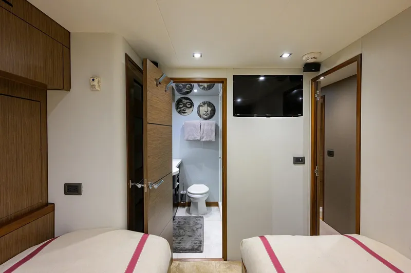 Slide: The Image of Interior of 2013 Hatteras 80 Motor Yacht cabin with ensuite bathroom and modern decor. - 33
