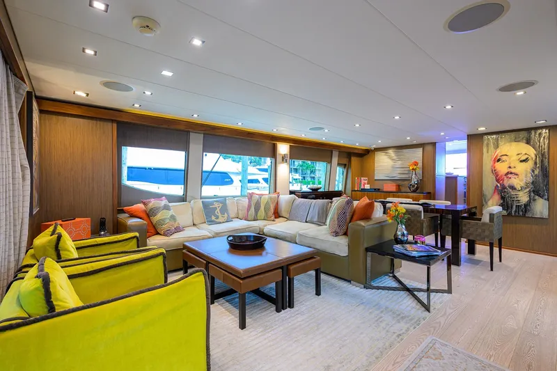 Slide: The Image of Luxurious interior of 2013 Hatteras 80 Motor Yacht with modern decor and vibrant seating. - 4