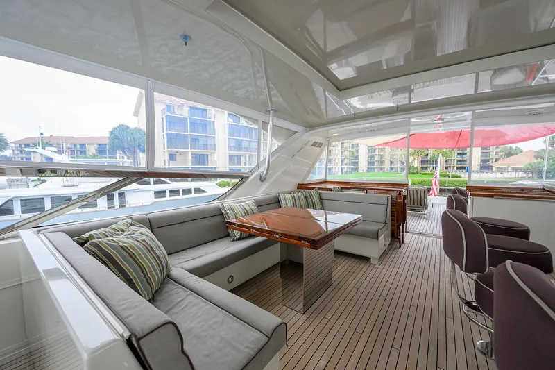 Slide: The Image of Luxurious interior of 2013 Hatteras 80 Motor Yacht with elegant seating and wooden accents. - 48