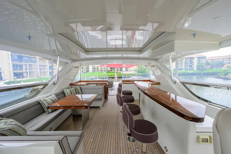 Slide: The Image of Luxurious interior of 2013 Hatteras 80 Motor Yacht with elegant seating and bar area. - 49