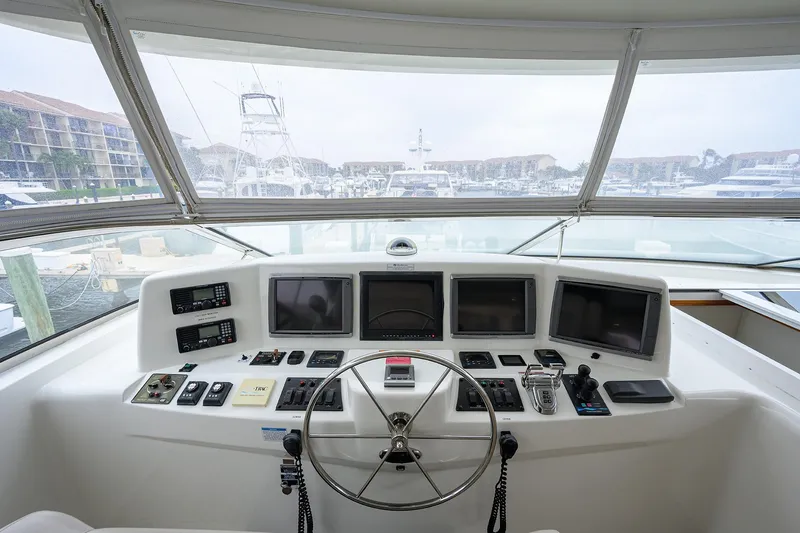 Slide: The Image of Helm of 2013 Hatteras 80 Motor Yacht with navigation screens and controls. - 52