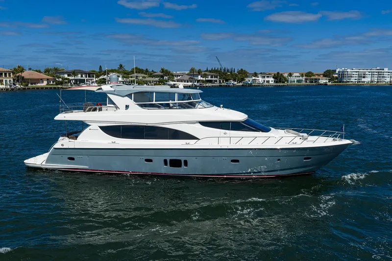 Slide: The Image of 2013 Hatteras 80 Motor Yacht cruising on a sunny day near waterfront homes. - 55