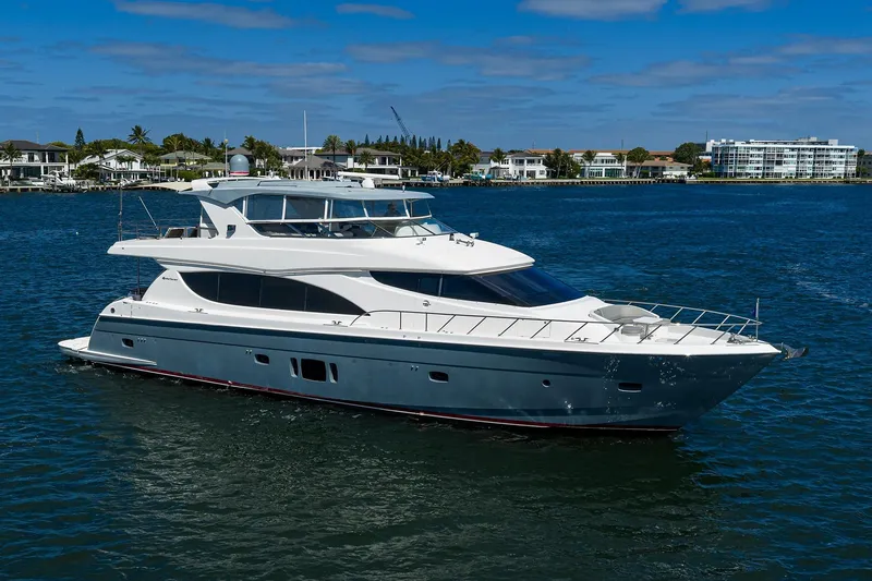 Slide: The Image of 2013 Hatteras 80 Motor Yacht cruising on a sunny day near waterfront homes. - 57