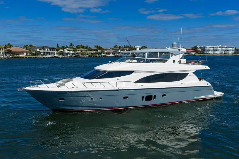 Slide: The Image of 2013 Hatteras 80 Motor Yacht cruising on a sunny day near waterfront homes. - 62