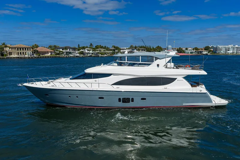 Slide: The Image of 2013 Hatteras 80 Motor Yacht cruising on a sunny day near waterfront homes. - 64