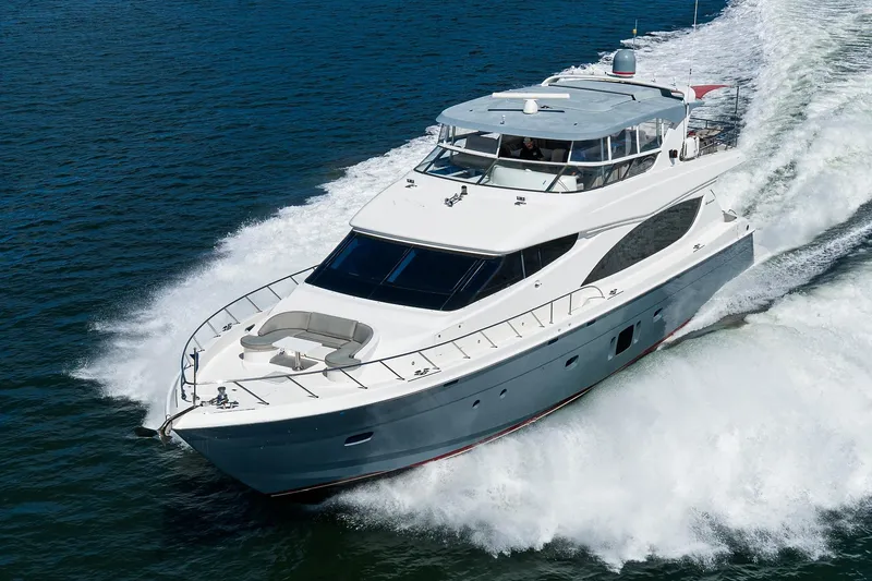 Slide: The Image of 2013 Hatteras 80 Motor Yacht cruising swiftly on open water. - 77
