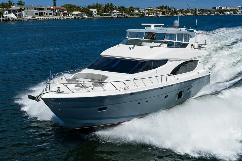 Slide: The Image of 2013 Hatteras 80 Motor Yacht cruising on a sunny day, near waterfront homes. - 78